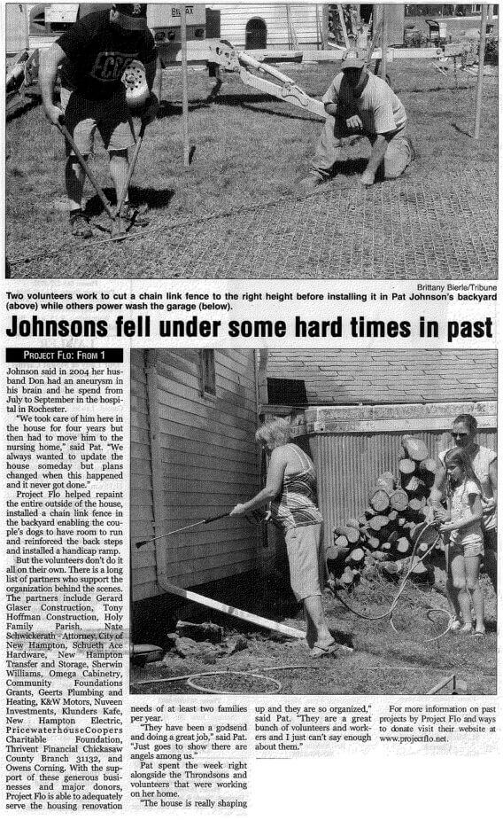 Volunteers build a chain link fence while others power wash a garage. A woman paints a wall. Caption reads "Johnsons fell under some hard times in past." Logs and tools visible.